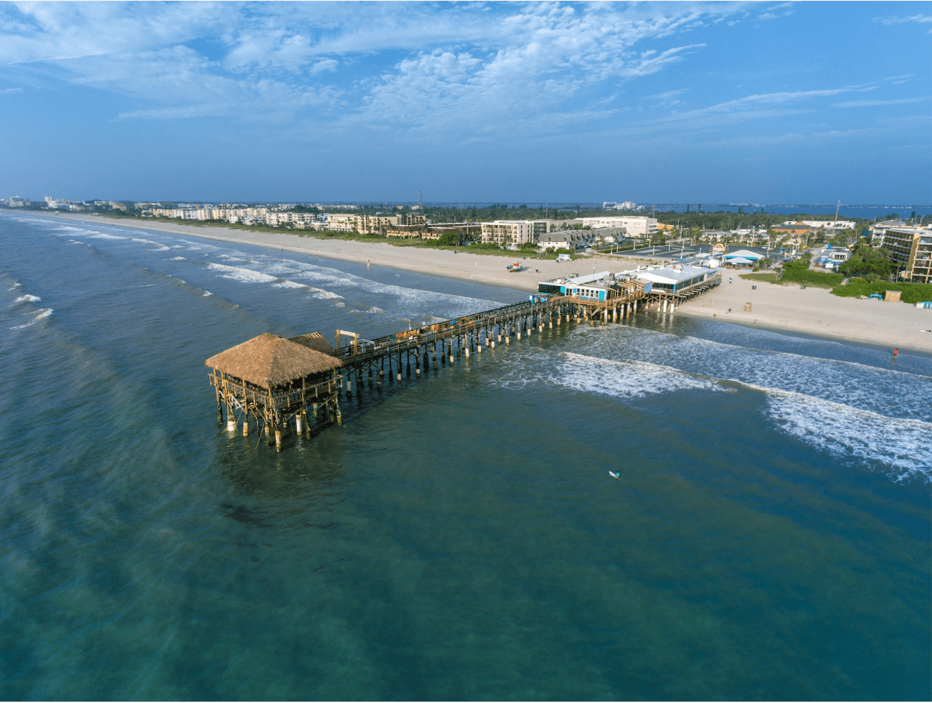 Aerial view of Cocoa Beach Pier extending into the Atlantic Ocean