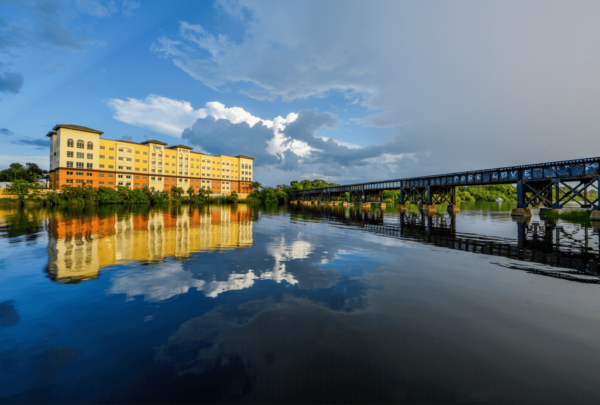 Crane Creek waterfront with railroad bridge reflecting in calm water at golden hour